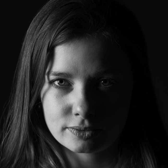 Dramatic black and white portrait highlighting intense gaze of a woman in Paris.